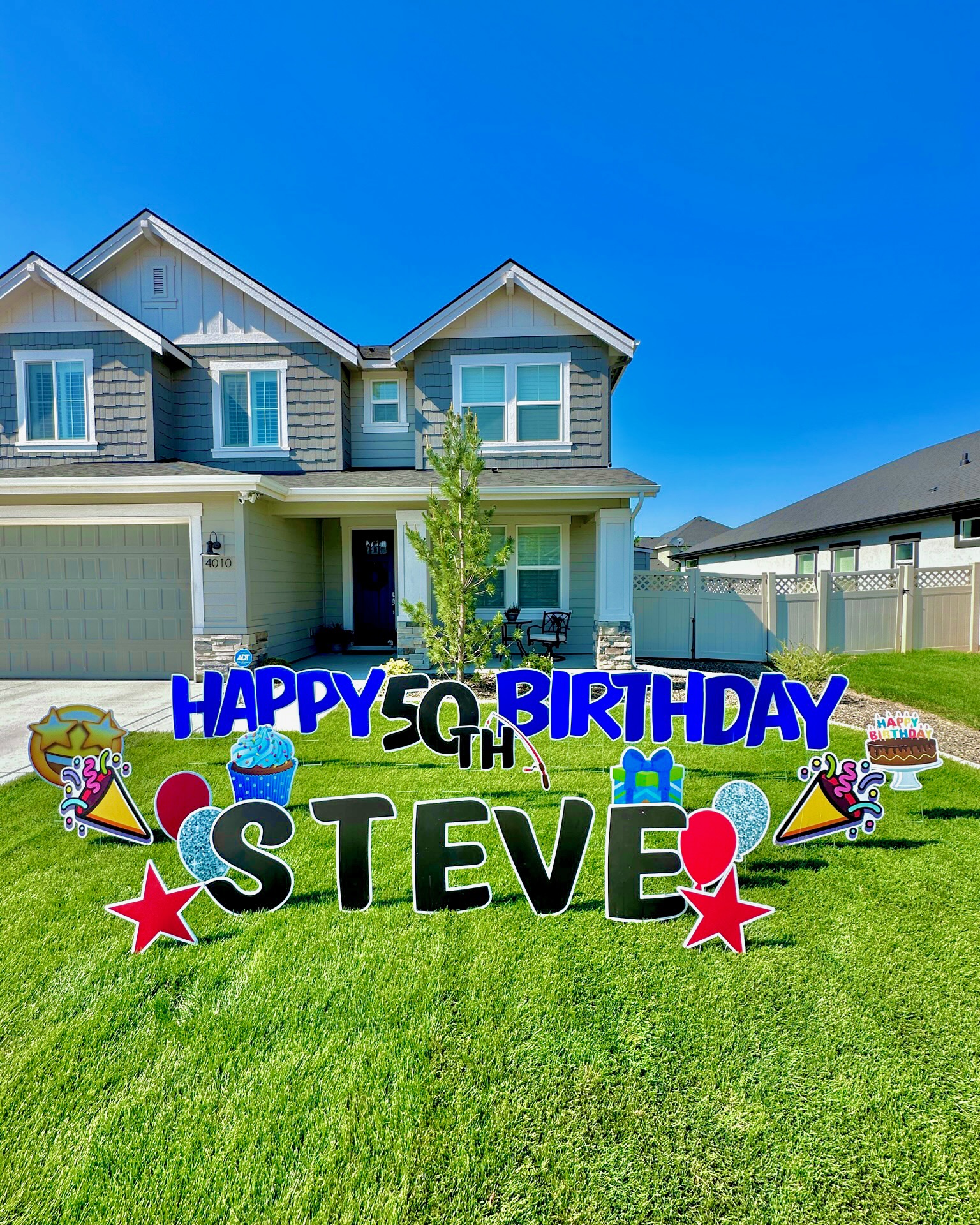 Happy 50th Birthday Steve yard card display with colorful letters, cupcake art, and party decorations on a Boise Idaho lawn