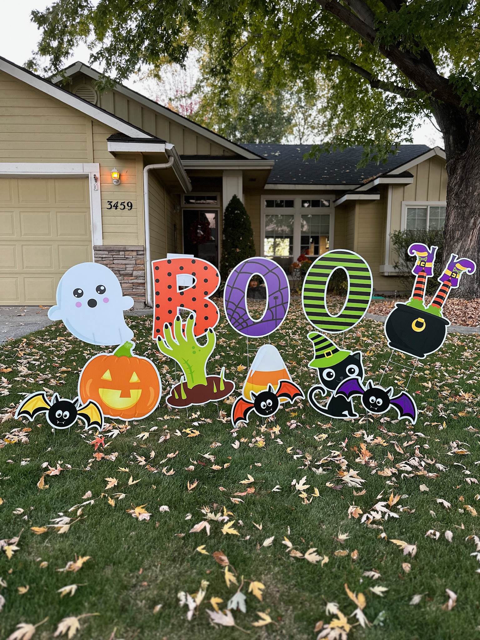 Halloween BOO yard card display with ghost, pumpkin, and colorful spooky art in a Boise front yard